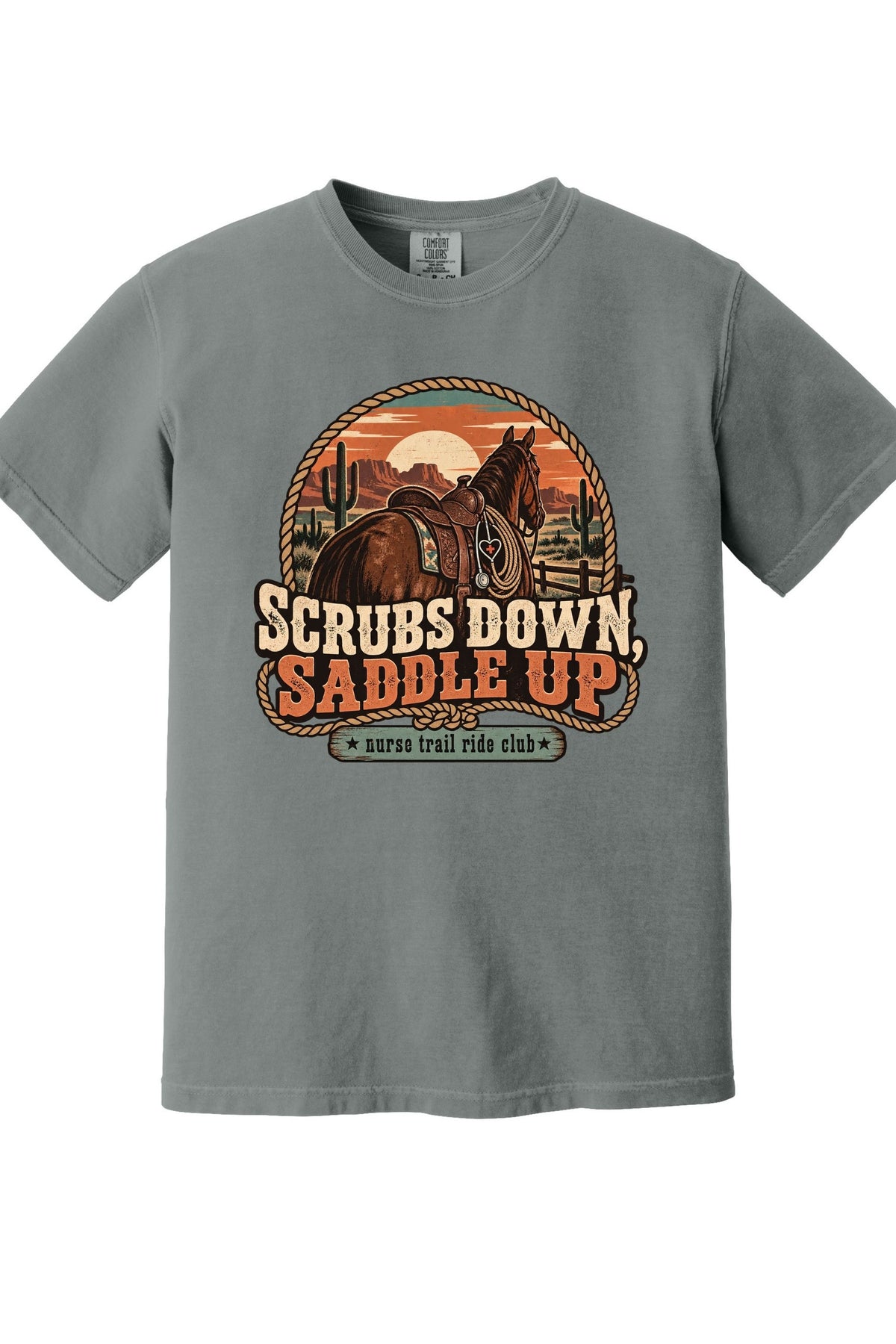 A heather gray short-sleeve crewneck t-shirt featuring a retro western graphic of a horse and rider with the text 'SCRUBS DOWN, SADDLE UP' and 'survival ride club'.
